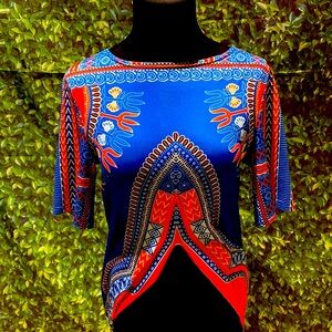 A silk African print shirt with long flaps on the sides and medium length sleeve